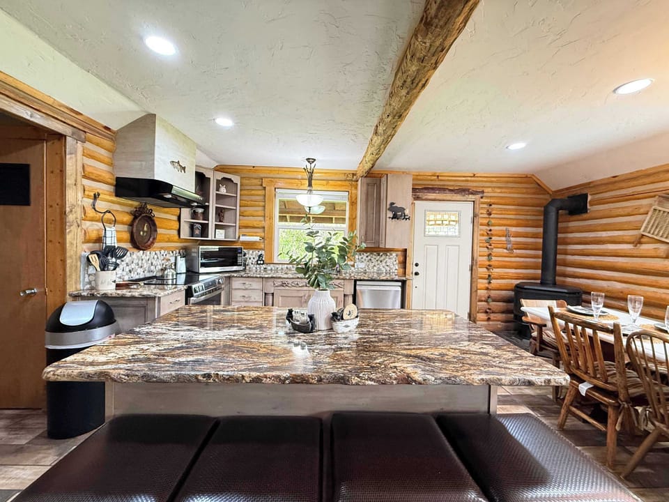 Whip up delicious family meals in the expansive kitchen, featuring a massive premium granite island with comfortable leather-cushioned barstools.