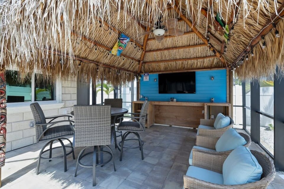 Tiki hut area with ample seating and large screen TV