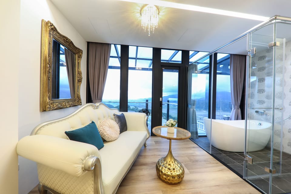 Luxury Double Room, Partial Ocean View | Bathroom | Separate tub and shower, hair dryer, slippers, towels