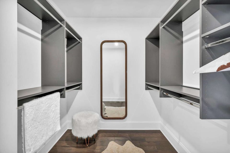 Enjoy the luxury of a spacious walk-in closet in the master bedroom, featuring ample shelving and hanging space. Perfect for keeping all your belongings organized and easily accessible during your stay.