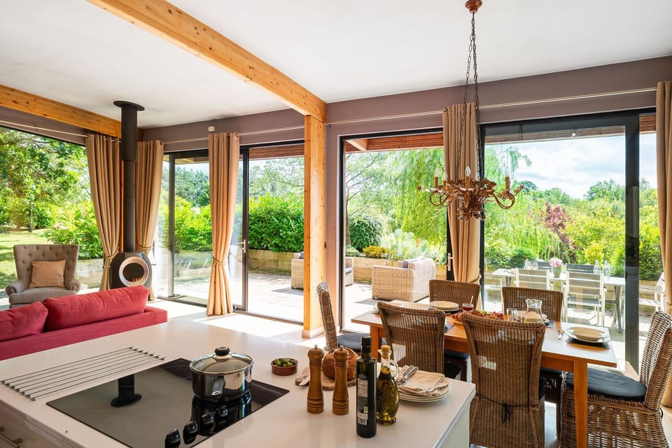 Open-plan living space with lounge and modern kitchen in Jules lodge at Brompton Lakes.