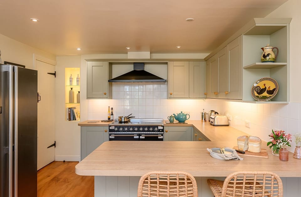 Well-equipped farmhouse kitchen at Hollins Farmhouse holiday home in the Yorkshire Dales with a breakfast island and range cooker.