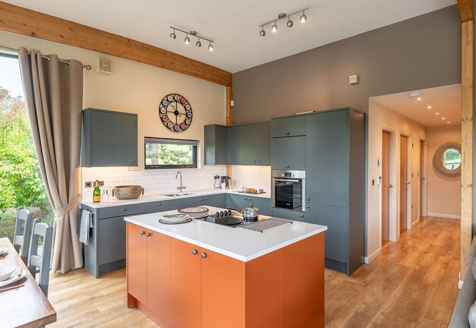 Contemporary kitchen in William lodge at Brompton Lakes with central island, modern appliances and spacious open-plan layout.