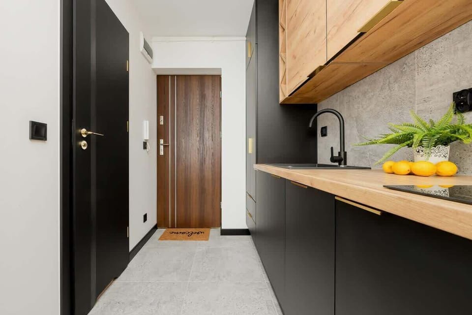 Contemporary kitchen with dark cabinets, wood finishes, and open layout.