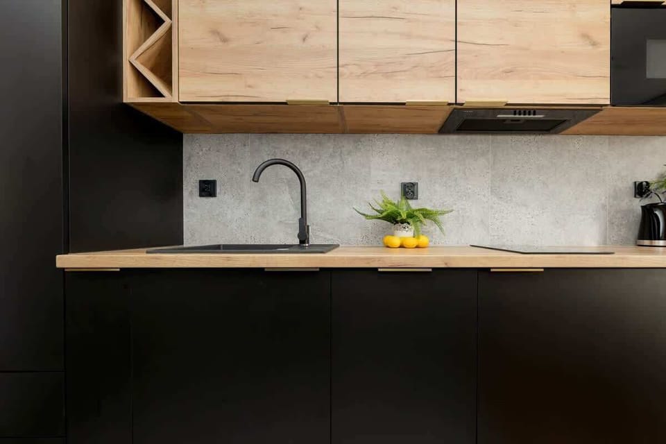 Contemporary kitchen with dark cabinets, wood finishes, and open layout.