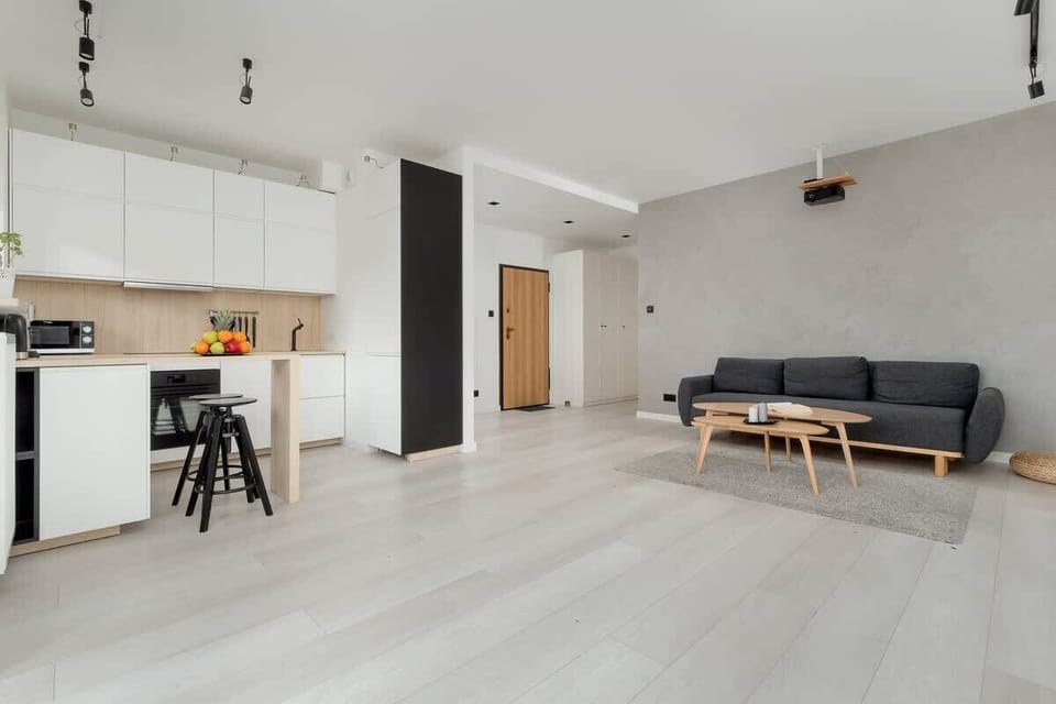 A modern lounge with a cozy ambiance, wall-mounted artwork, and a spacious layout.