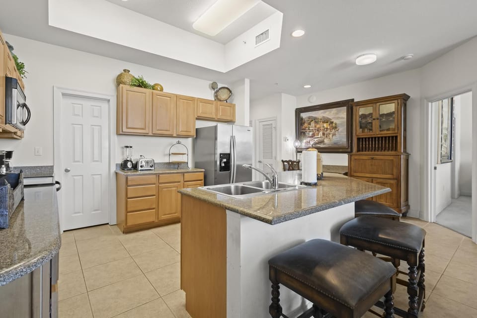 Kitchen - The kitchen is fully equipped with stainless steel, whirlpool appliances, and features a large, eat-in bar.