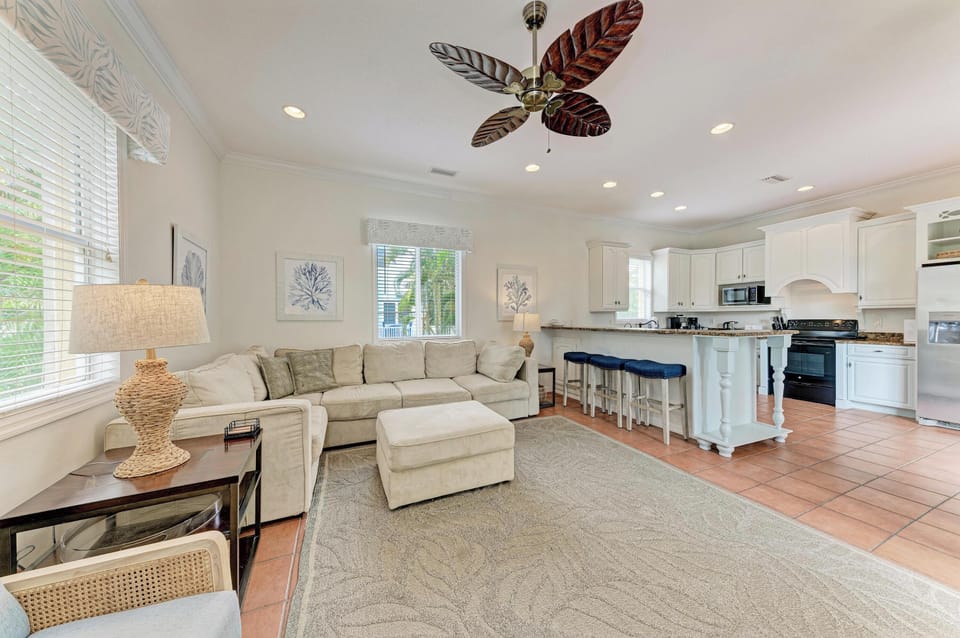 Unwind in this airy open-concept living space with plush seating, a coastal vibe, and a fully-equipped kitchen for preparing your favorite meals.
