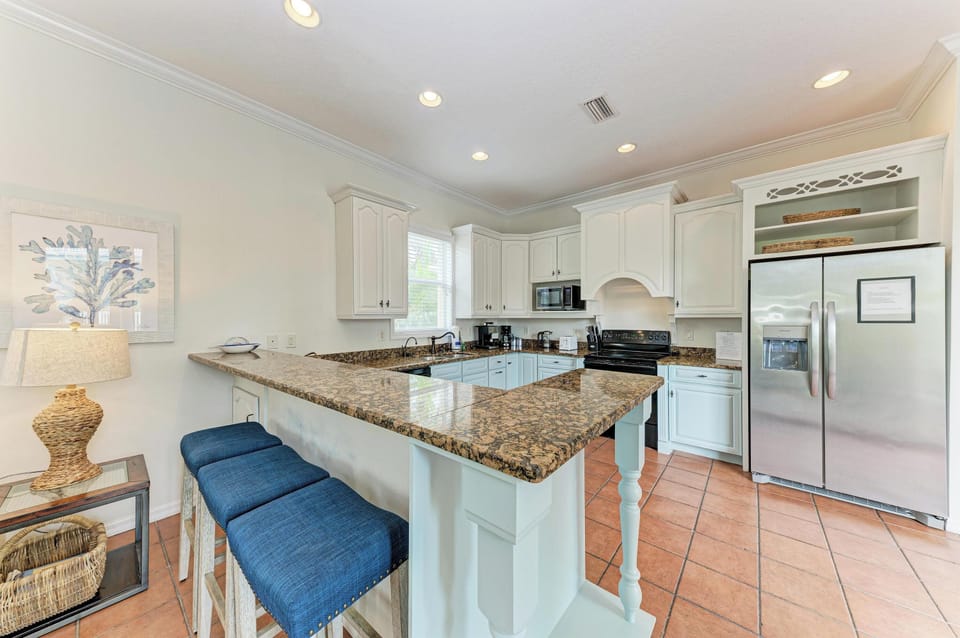 Your fully equipped kitchen features granite countertops, modern appliances, and a spacious island with bar seating—perfect for cooking and gathering together.