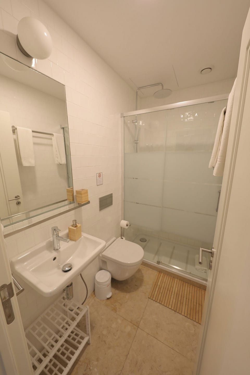 Shower, rainfall showerhead, hair dryer, towels