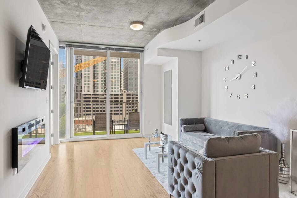 Welcome to this stunning open floor plan condo living room, where modern elegance meets panoramic natural beauty. The open floor plan design allows for a free flow of energy and movement, creating a sense of spaciousness and connectivity.