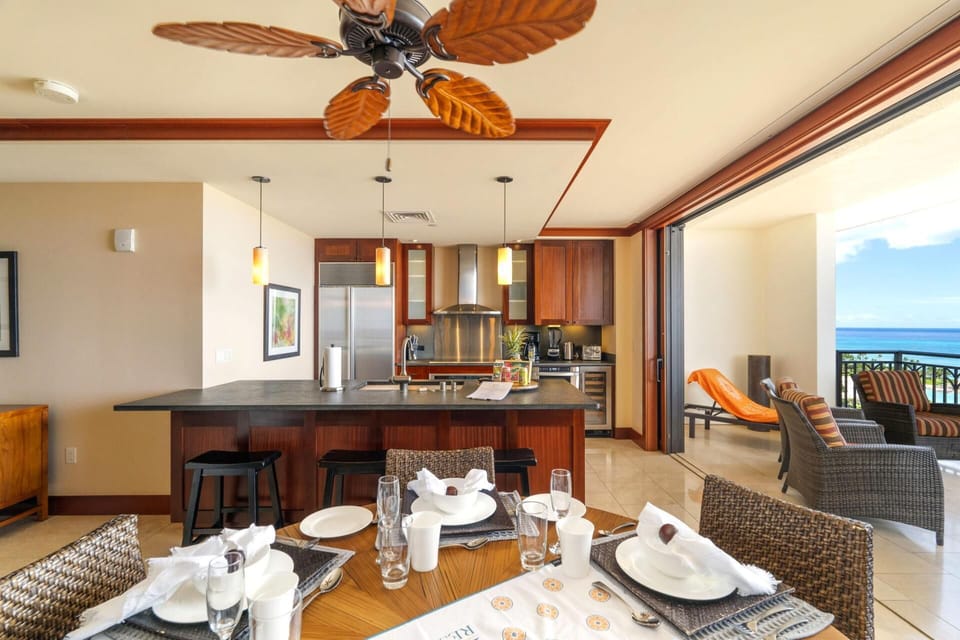With ceiling fans shaped like palm leaves and napkins folded like origami dreams, this space is a tropical waltz    