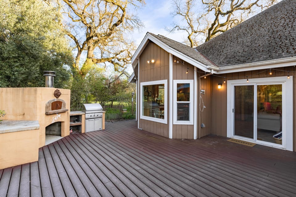 Spacious deck features an outdoor kitchen.