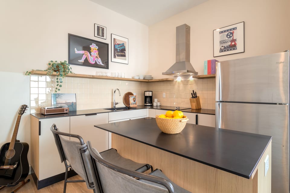 This studio's fully equipped kitchen features an island with barstool seating. 