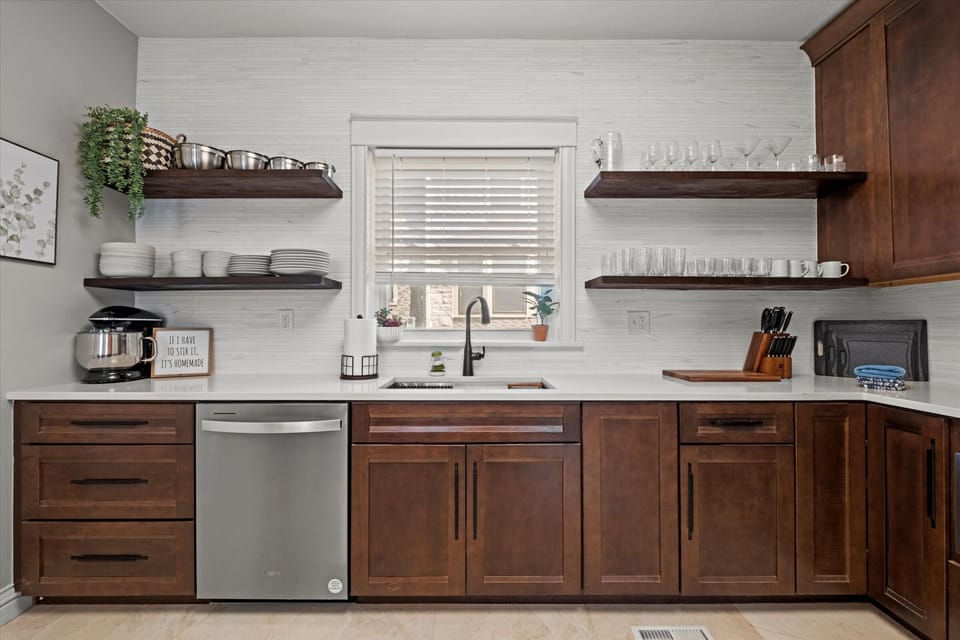 Thoughtfully organized kitchen with open shelving, glassware, dishes, and essentials—ideal for extended stays near Country Club Plaza.