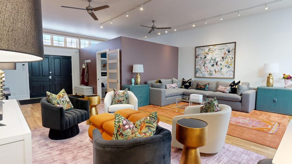 Your downtown sanctuary: the living area blends industrial loft style with plush furnishings and vibrant color.