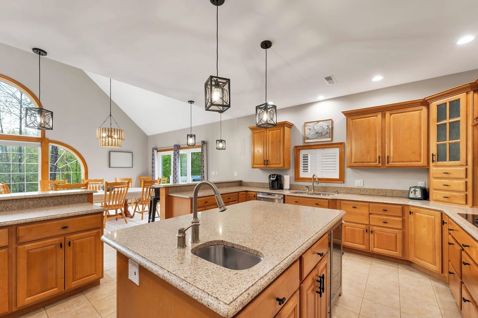 Well-equipped kitchen with bar sink and beverage fridge in the island