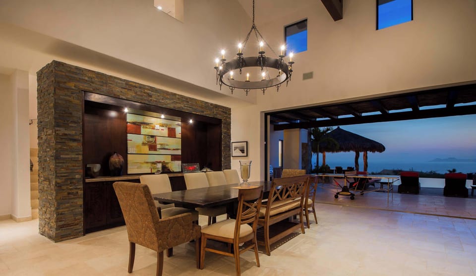 Enjoy a cozy dinner in this elegantly designed dining area, with stunning views just beyond.