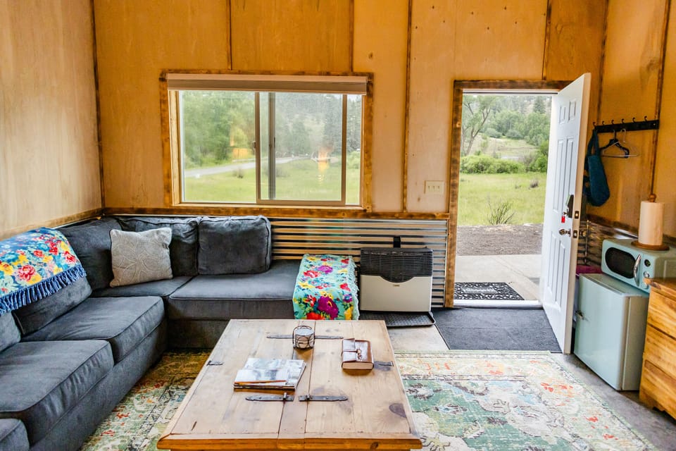 Cozy mountain cabin interior with open living space and peaceful nature views