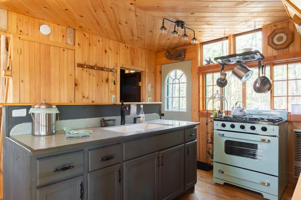 Fully equipped airy bright kitchen with vintage cook stove replica.