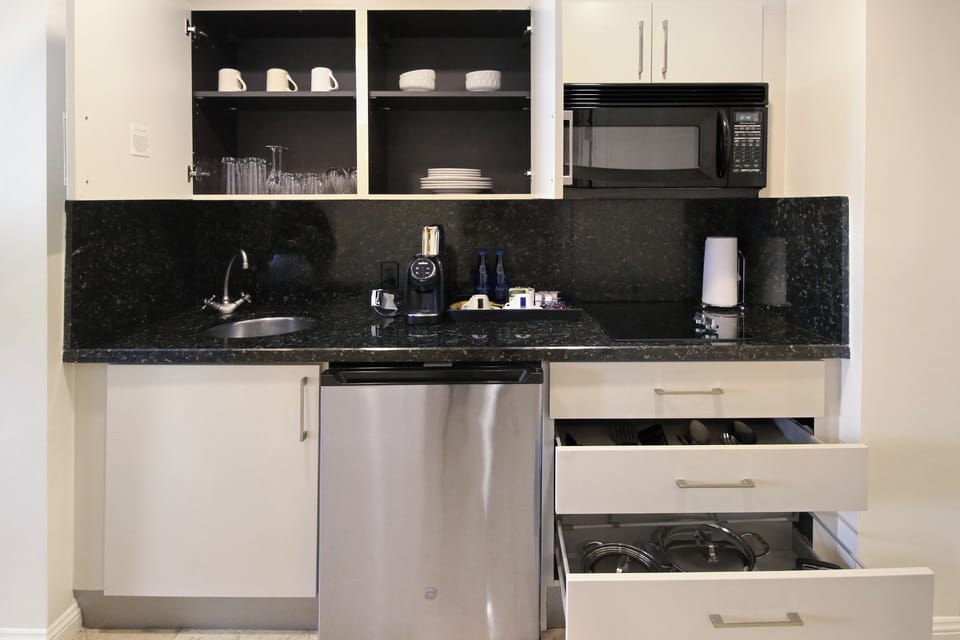 Fully stocked kitchen with pots & pans, silverware, dishes, glasses & utensils. 