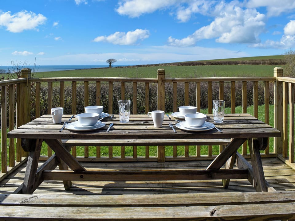 Decked terrace with outdoor furniture | Selker View - Moorside Glamping Pods, Corney, near Millom