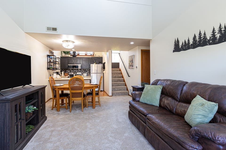 Open concept living room with adjoining dining room & kitchen