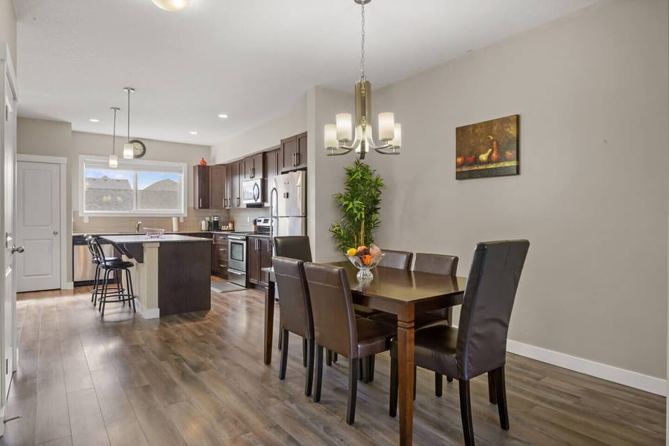 Open-concept dining area connected to a fully equipped kitchen.