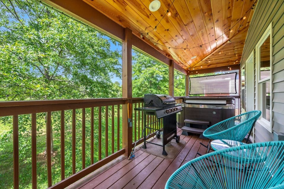 The back deck also has string lights as well as a full-sized hot tub. The gas BBQ grill has been replaced with a charcoal grill in the front yard.