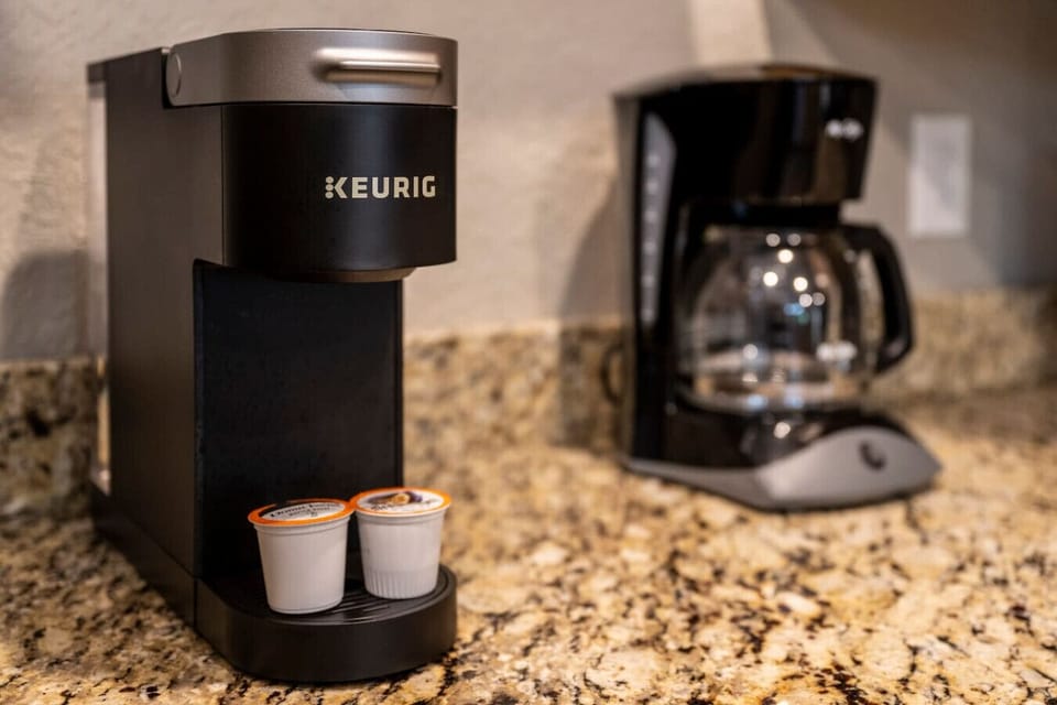 A Keurig and traditional coffee pot are both available to provide options for your morning cup of coffee.