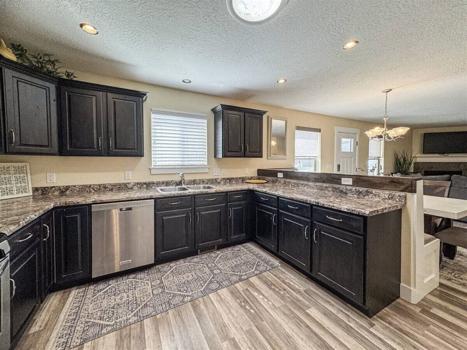 Spacious kitchen with sleek appliances, rich cabinetry, and ample counter space—perfect for cooking and gathering.