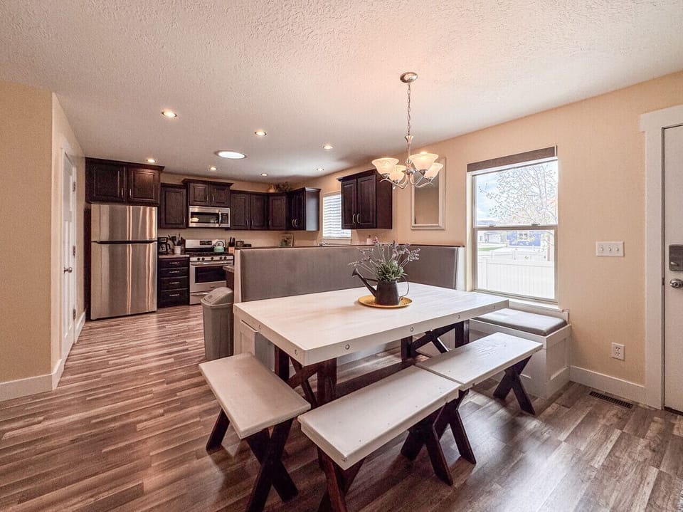 Charming dining nook with cozy bench seating, natural light, and open flow to a modern kitchen.