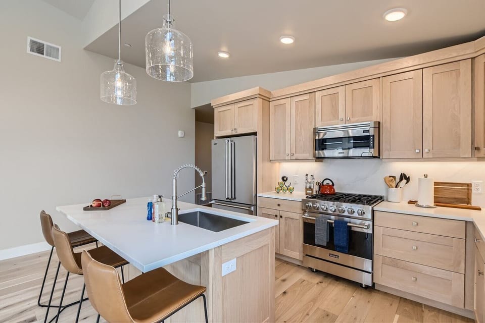 Prepare a gourmet meal in this chef-inspired kitchen featuring sleek quartz countertops and a spacious island with seating.
