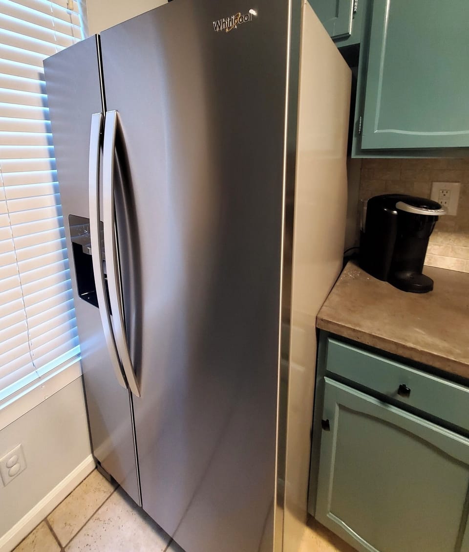 New refrigerator has an automatic ice and water dispenser on the freezer door.