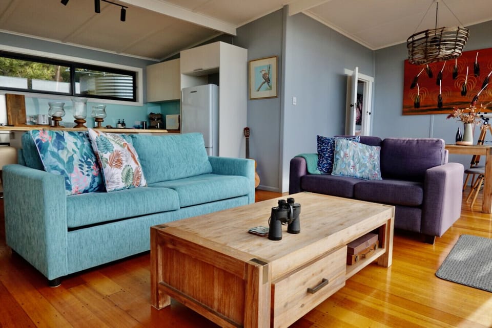 Open plan living and dining with door leading to bedroom and bathroom.