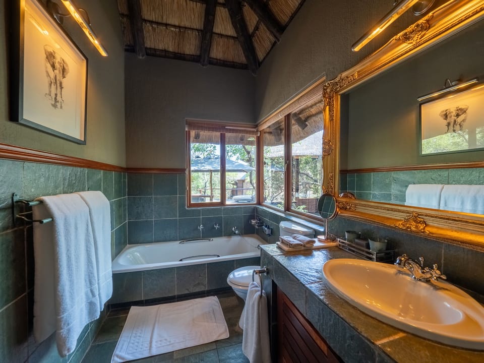 Luxury Suite, 1 King Bed, Non Smoking, River View | Bathroom | Separate tub and shower, hair dryer, slippers, towels