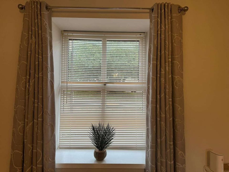 Daylight through cotton blinds.