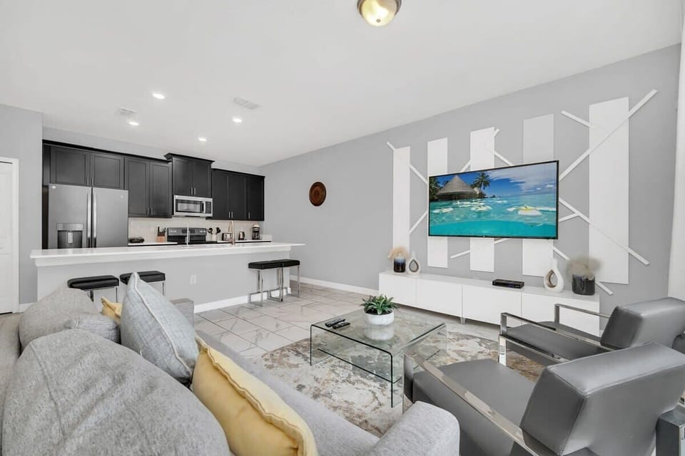 Kick back in the spacious living room with comfortable furniture, a large flat-screen TV, and complimentary high-speed Wi-Fi for the ultimate vacation experience.