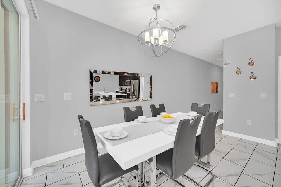 The spacious open-concept dining room has ample seating, making it easy for everyone to enjoy meals together after a day of Florida adventures.