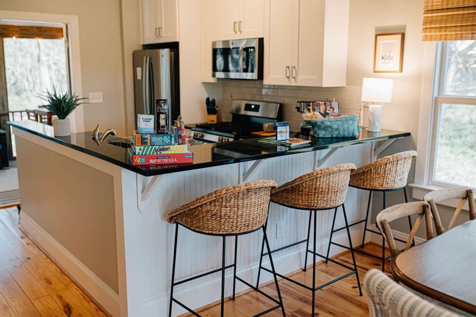 The breakfast bar at the kitchen counter is perfect for serving kids or enjoying a glass of wine.