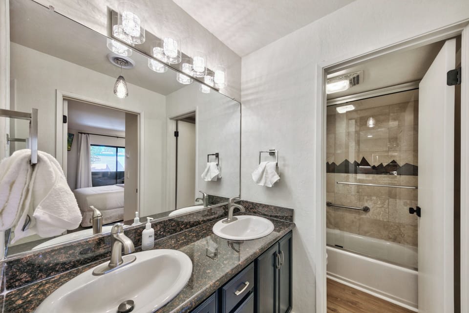 Pamper yourself in this elegant bathroom with dual sinks, granite counters, and a spacious shower for your morning routine.