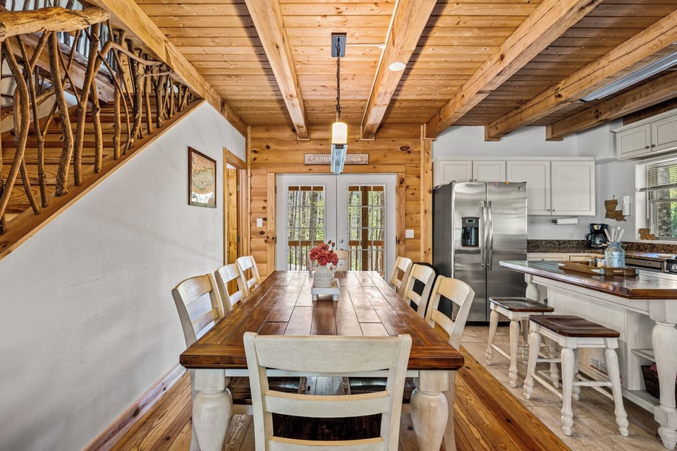 Gather and Feast: Spacious dining area with nature views and kitchen close by.