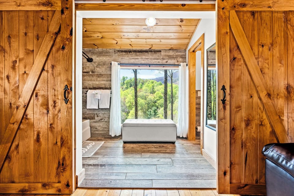 Spa Serenity with a View: Barn-door bathroom with stunning mountain backdrop.