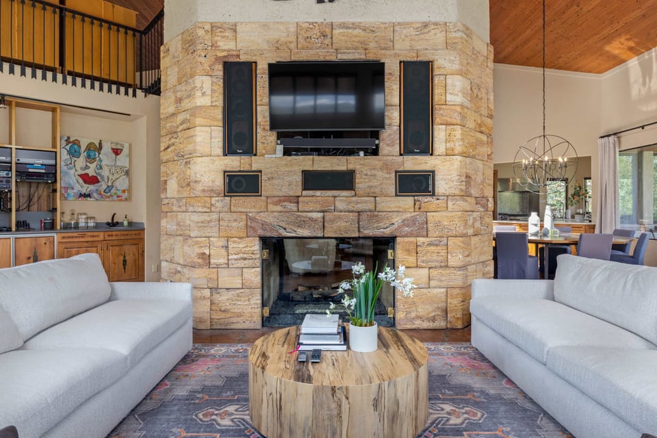 Living Room - Stone and wood finishes with dual fireplaces