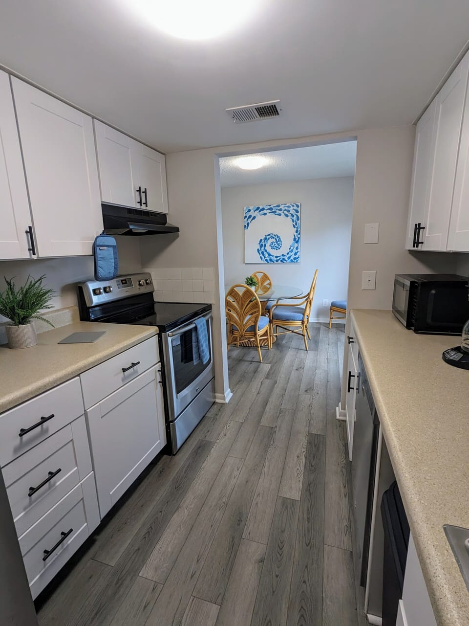 Full kitchen equipped with essentials such as pots and pans, dishes, glasses etc