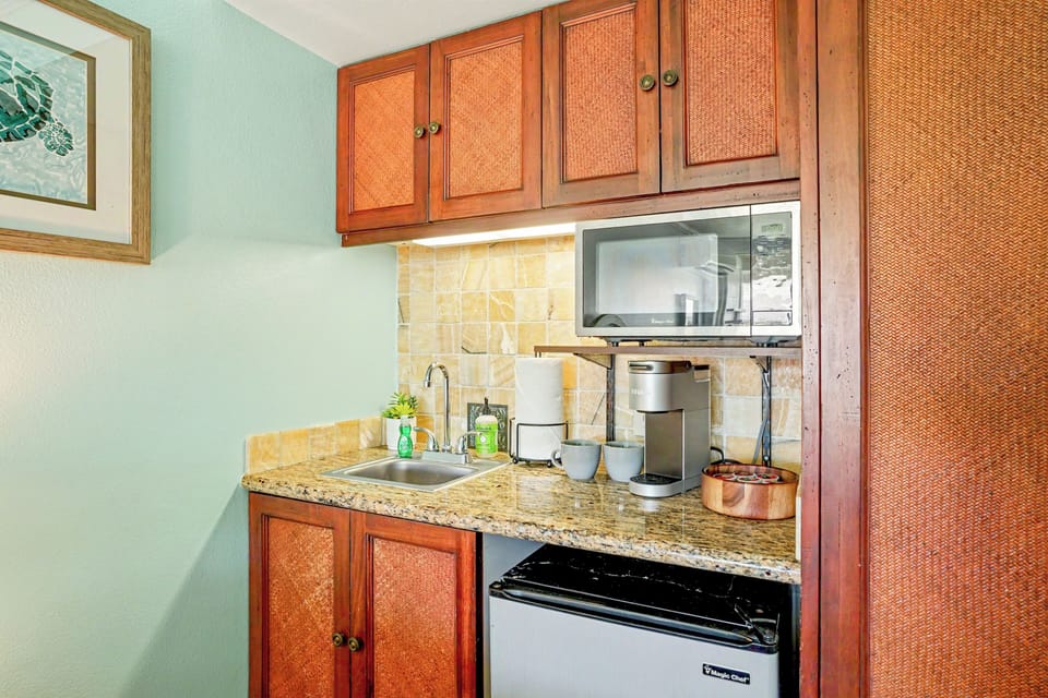 Kitchenette with mini fridge, microwave, dishes, utensils, Keurig and more. 