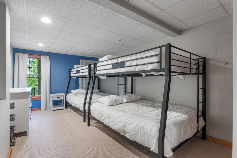 Bunk Room: Playful design with sturdy bunks and leafy views—perfect for adventurers!