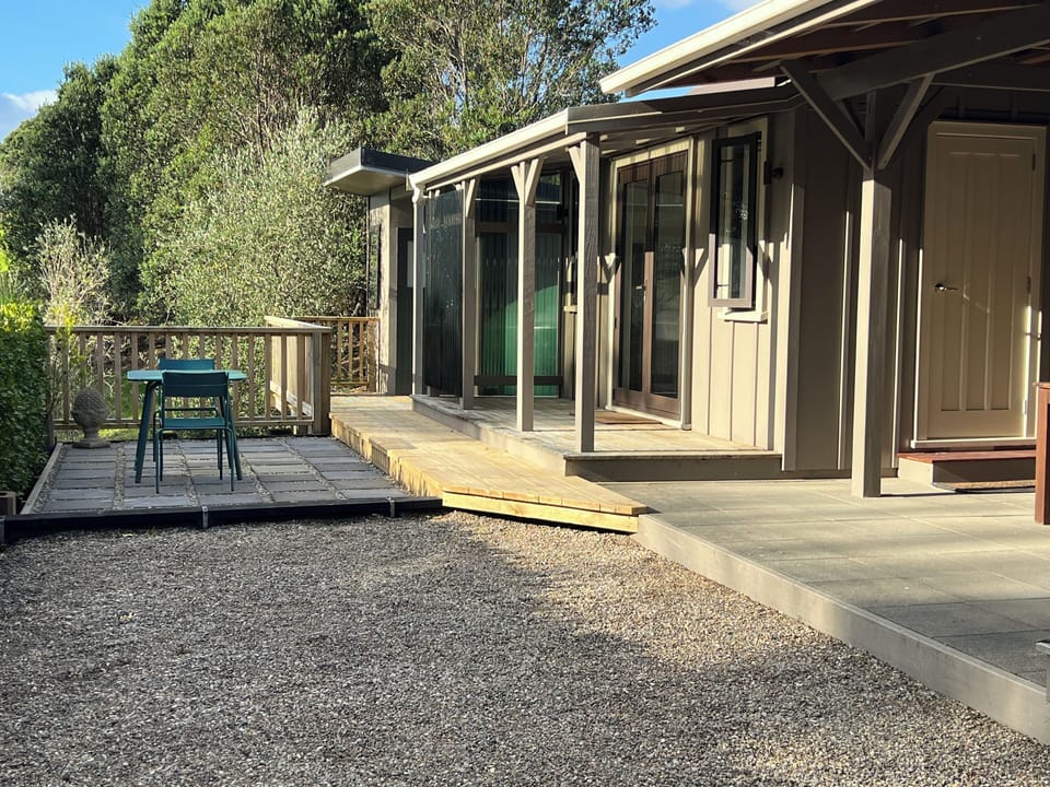 View of Cabin 2 and separate bathroom with shower and sink at end of photo.