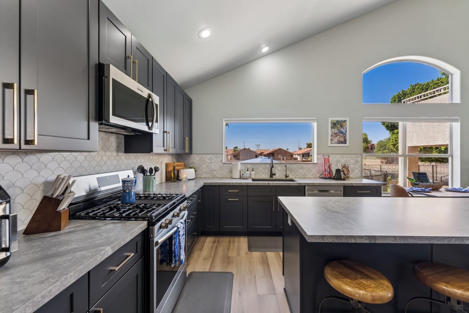 The pasta is boiling, chef calls out "Manga, Manga!", and as everyone gathers around you see Nonna in the corner smiling with approval. Spacious sink with stainless steel appliances including Smeg toaster, Fellow Kettle, gas stove, and microwave.