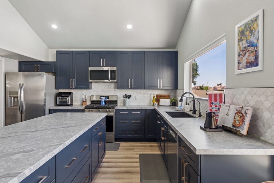 Kitchen with views to die for with overlooking the pool, pool table, game room, dining room, and living room.  kitchens were meant to be the center of the home and this one truly shines!